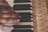 Close-up of hands practicing piano scales on a classic acoustic piano.