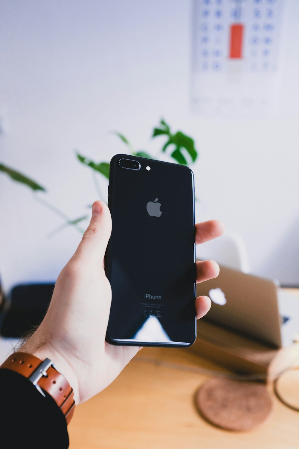 person's hand holding jet black iPhone 7 Plus