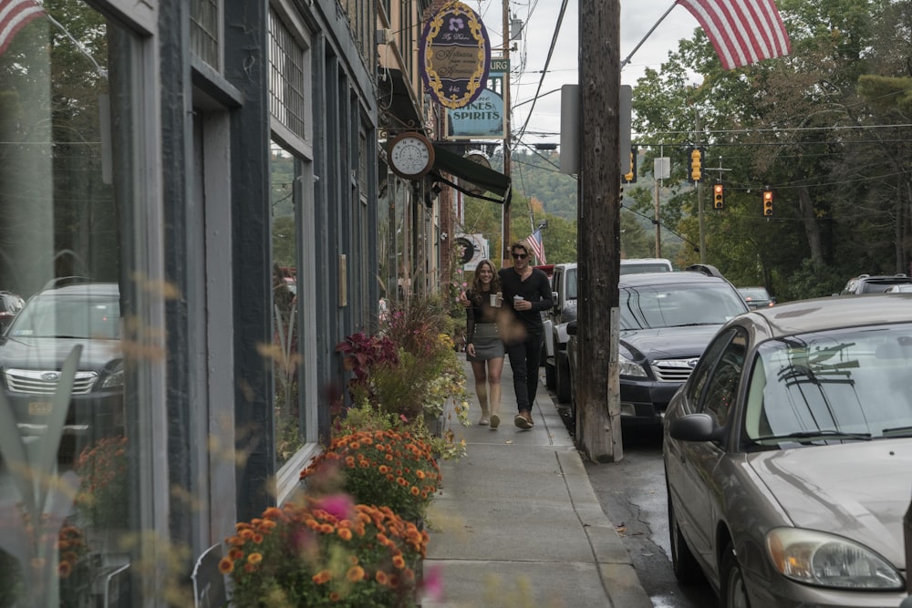 man and woman walking on sidewalk