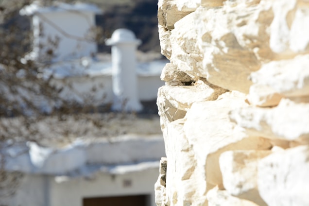 A serene architectural close-up highlighting smooth stone textures bathed in soft, natural light.