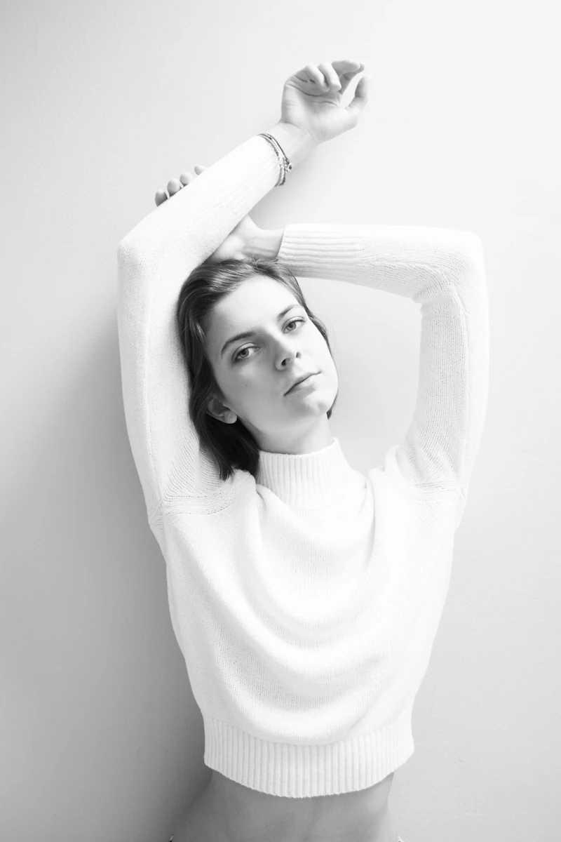 Model in a white ribbed long-sleeve top