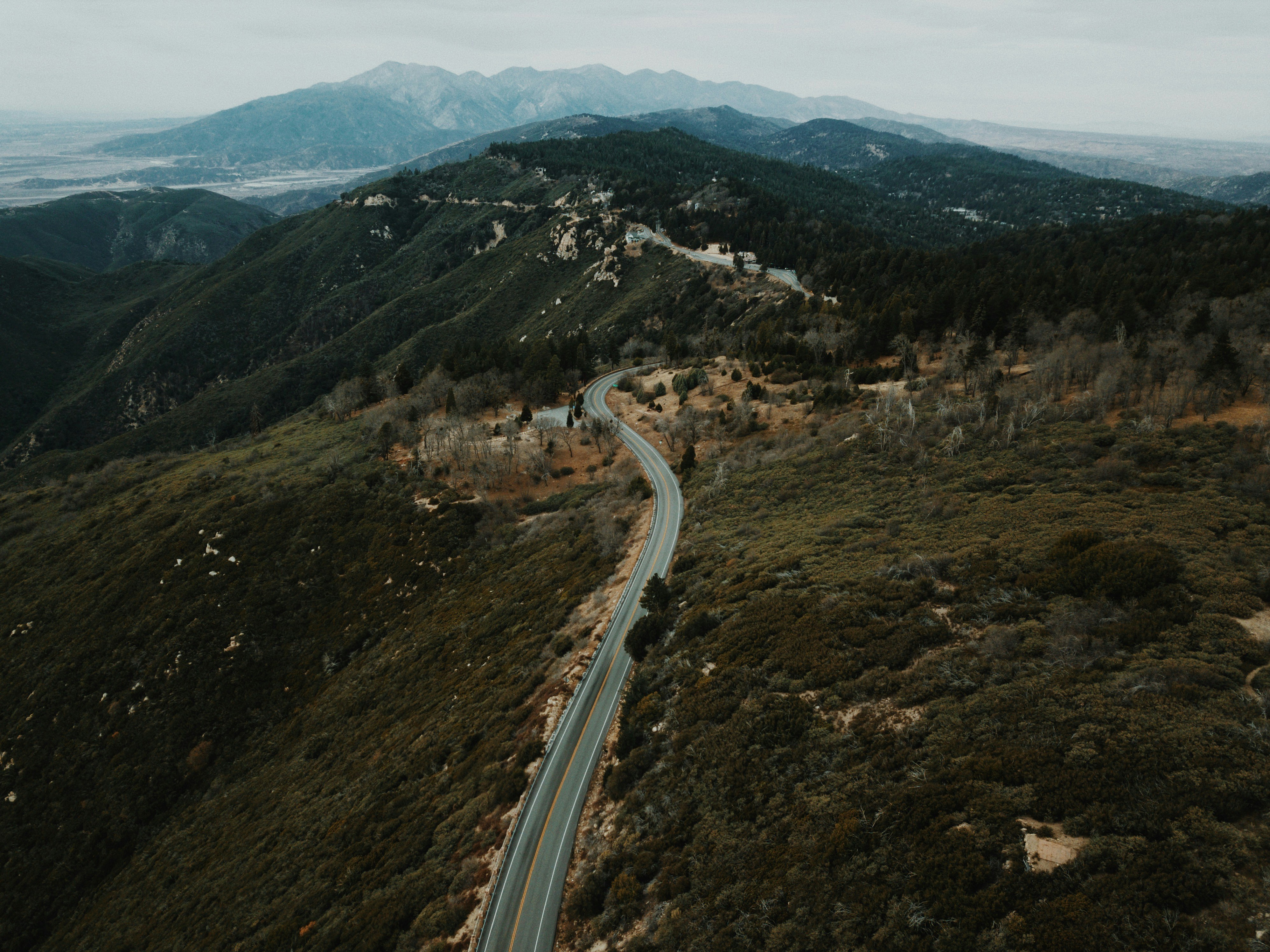 aerial view of road through mountains