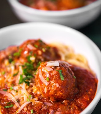 meta balls with noodles served on white ceramic bowl