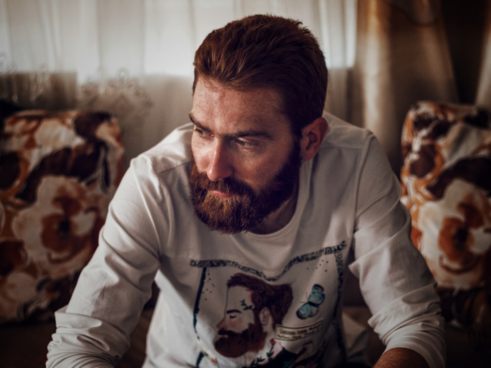 man in white long-sleeved shirt near white curtain