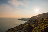 A scenic view of a coastal destination with tourists enjoying the sunset during a Braga Turismo tour.