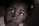 A close-up portrait of a young child gazing upwards. The image is in a sepia tone with soft lighting that emphasizes the child's expressive eyes. A subtle focus on the emotions conveyed through the child's facial expression.