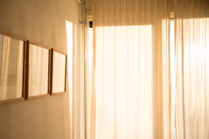 Soft natural light flooding the room, highlighting the warm minimalistic decor.