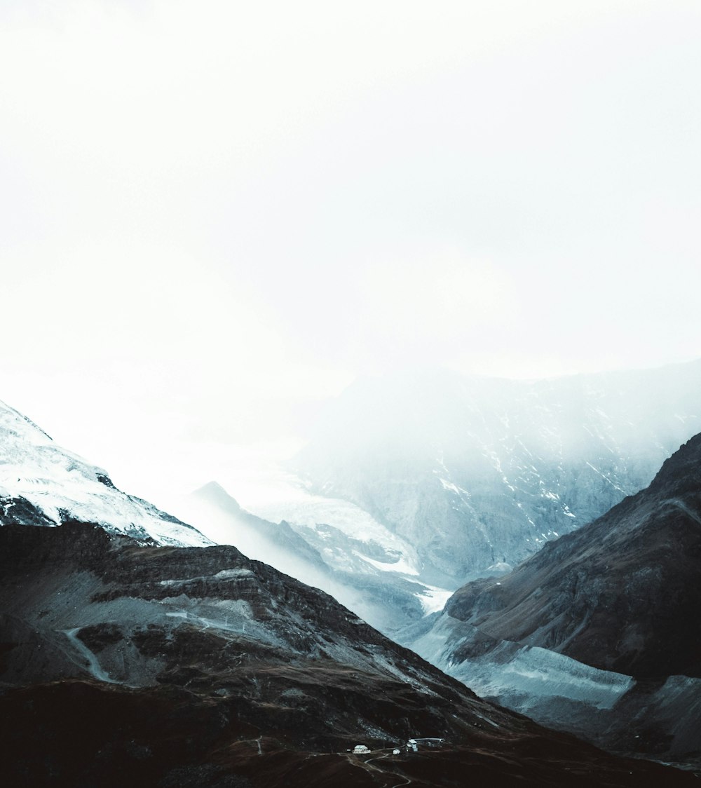 mountain cliff covered with snows covered with fogs