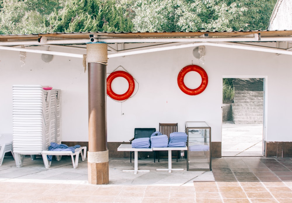 two red inflatable buoys hanging on white wall