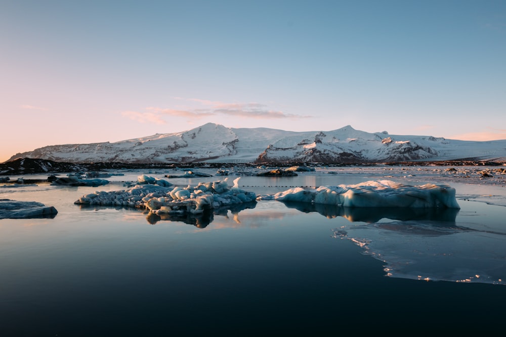 snow covered mountain under white and blue skies