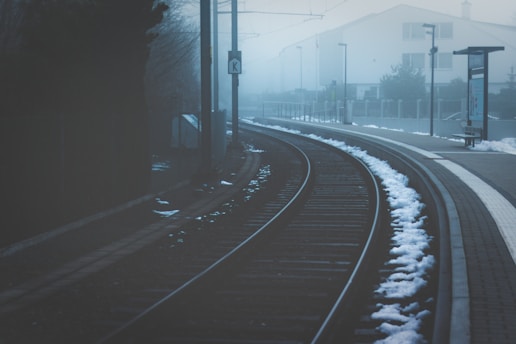 black railroad near buildings