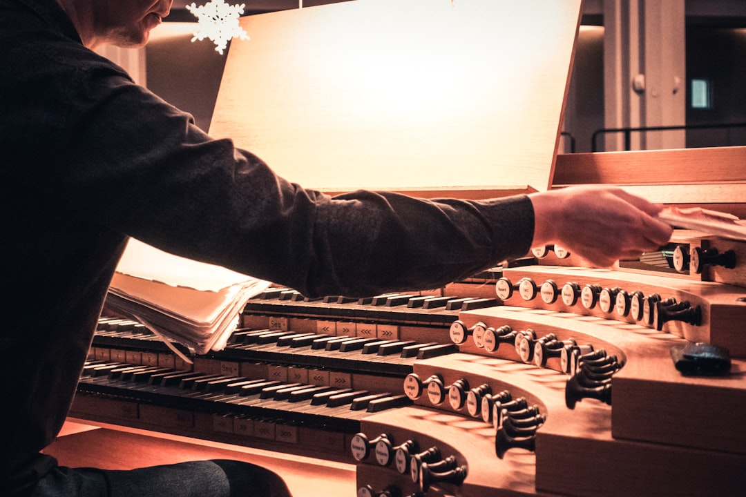 man playing brown musical instrument