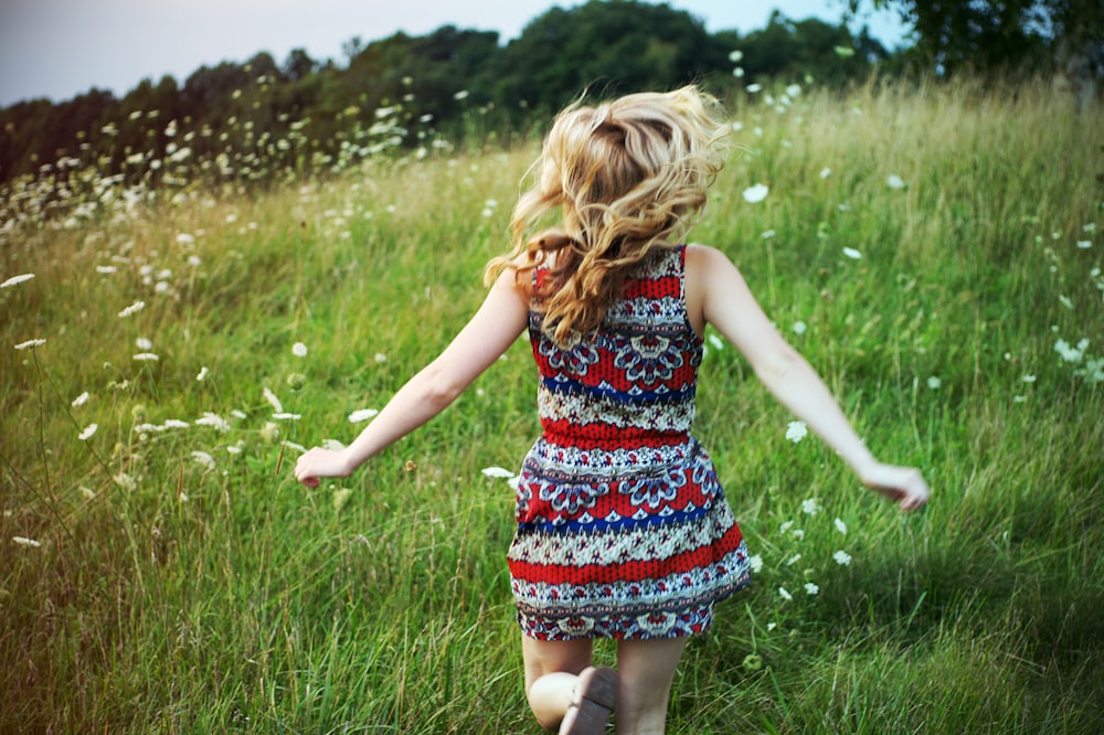 woman running in green grass