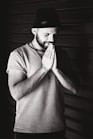 grayscale photography of a man praying