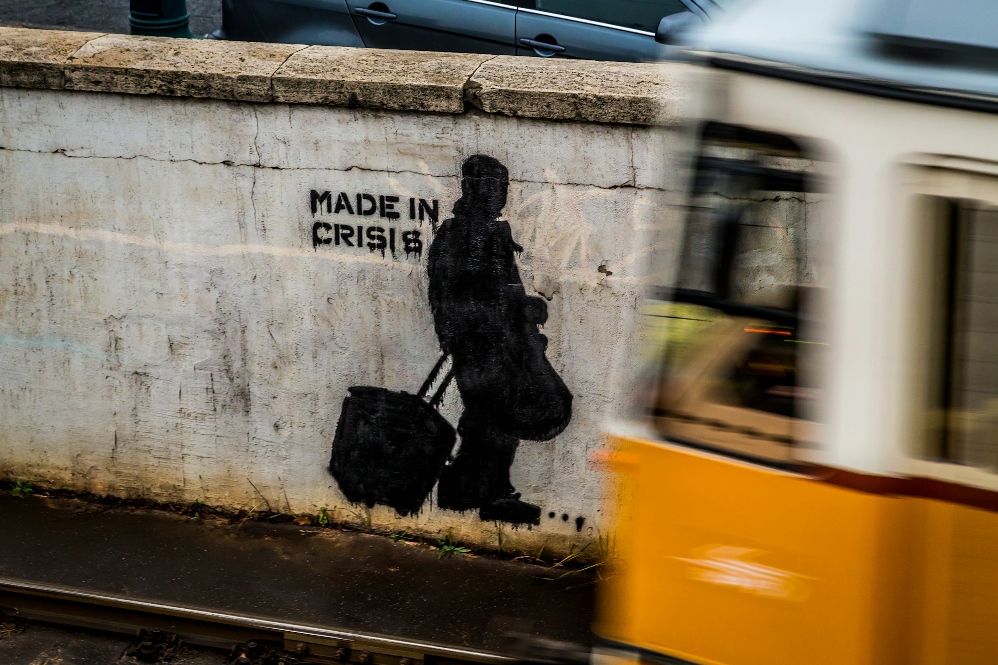 During a city trip to Budapest, Hungary, I saw this stencil street art on a wall at a metro line. For the photo, I chose a shutter speed slower than the metro expected would be and waited some minutes until the metro came.