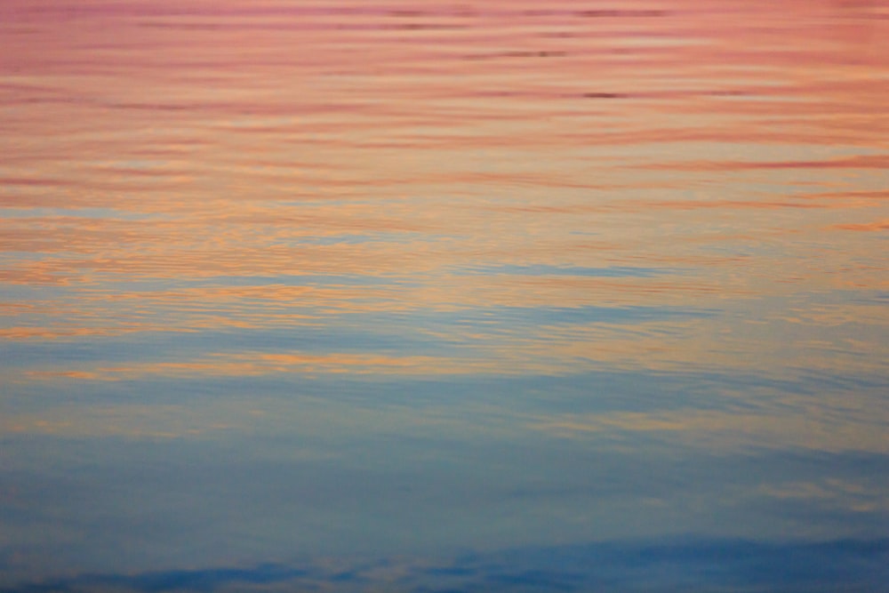 body of water under golden hour