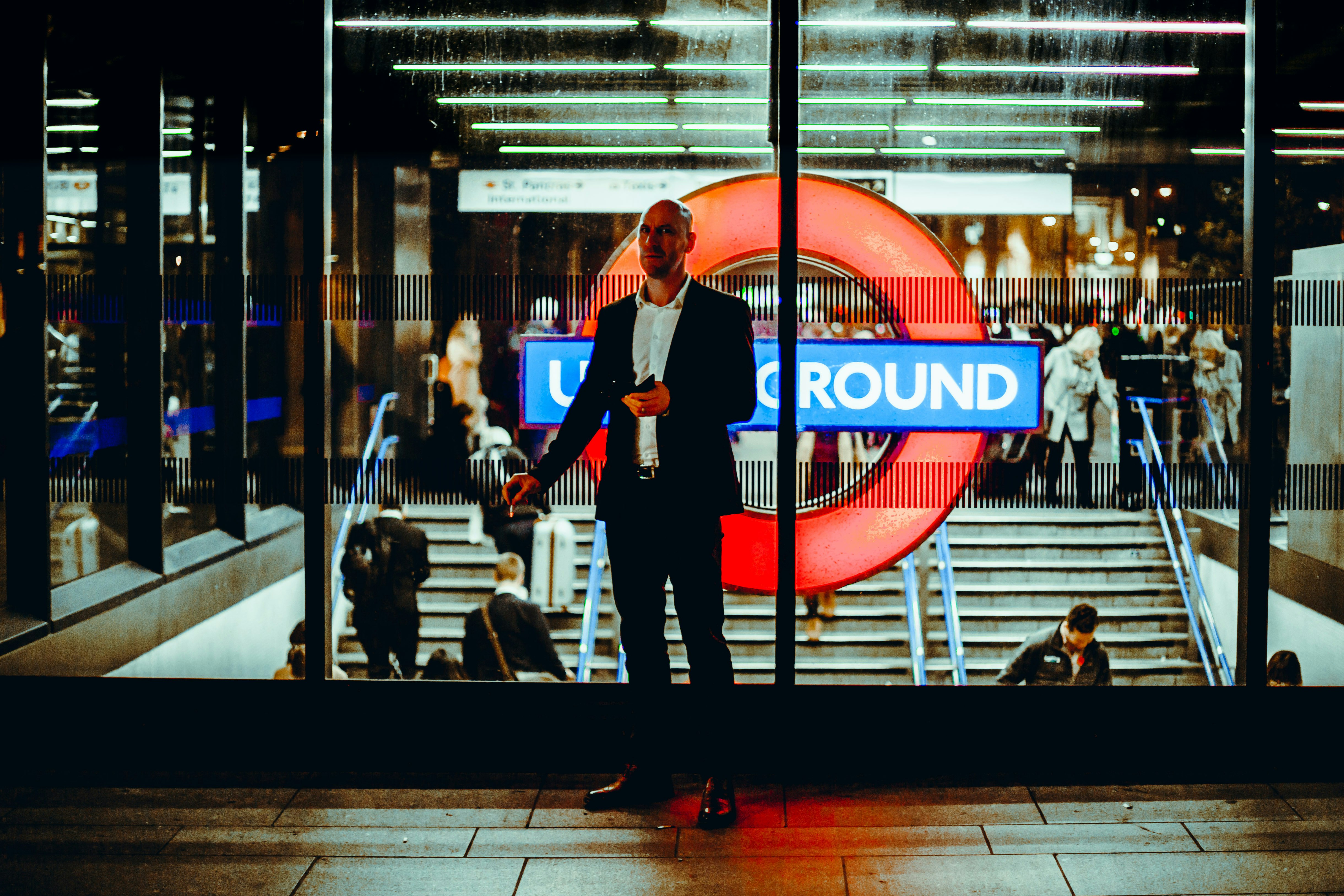 photo of man standing near glass