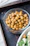 Close-up of a rustic bowl filled with black Etna chickpeas, highlighting their rich texture.
