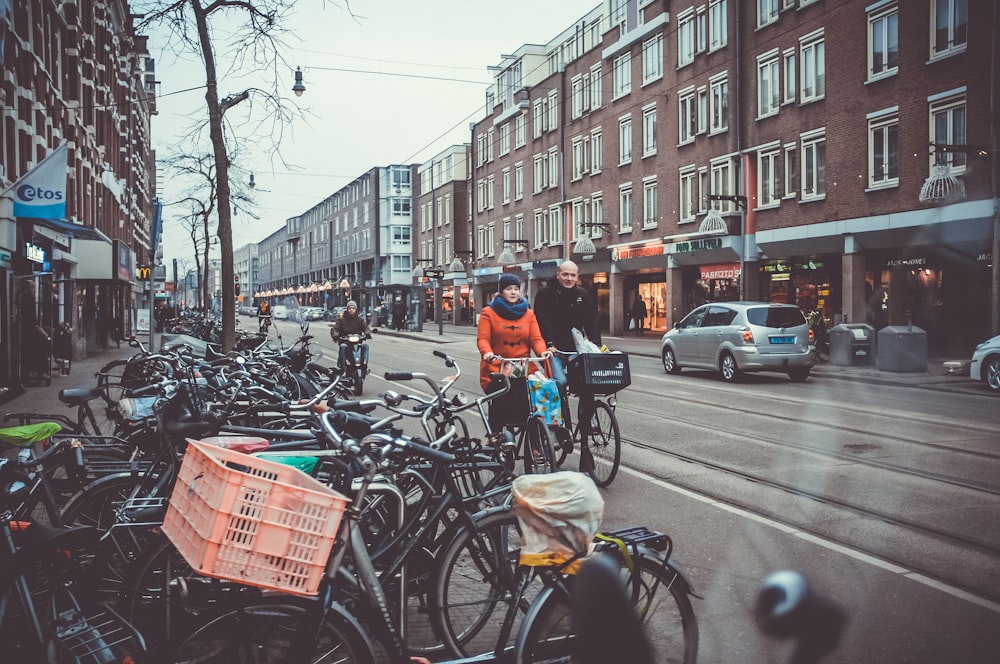 man and woman talking with bicycle on lane