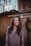 woman in gray V-neck knit shirt standing at the back of wooden parquet partition
