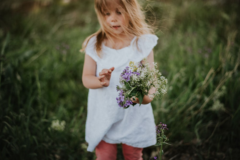 girl holding bouquet of flowers