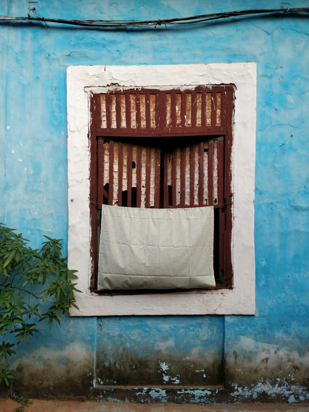 brown wooden window with gray curtain