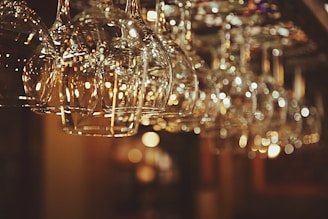 selective focus photo of line of clear drinking glasses