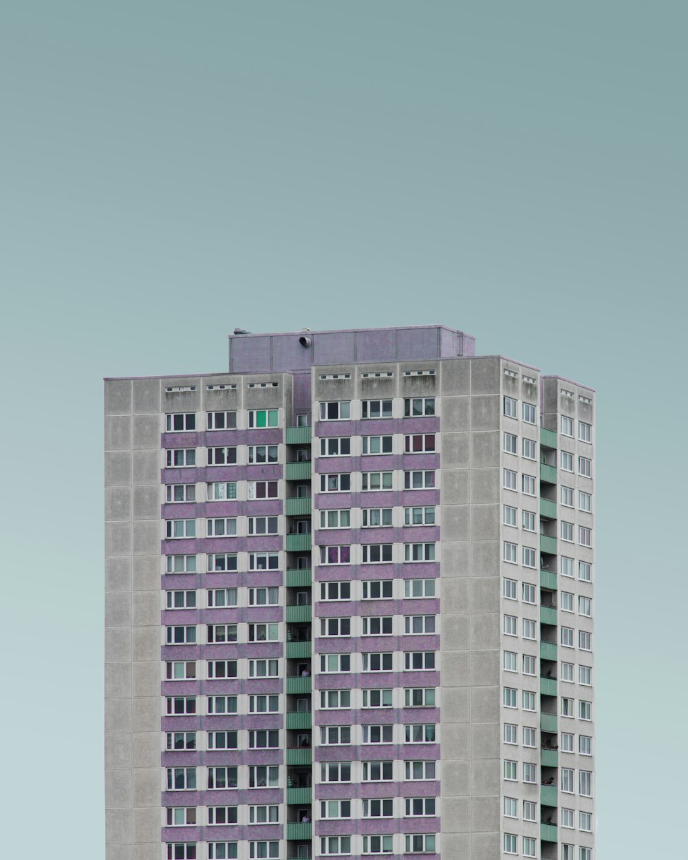 gray and purple high rise building under white clouds