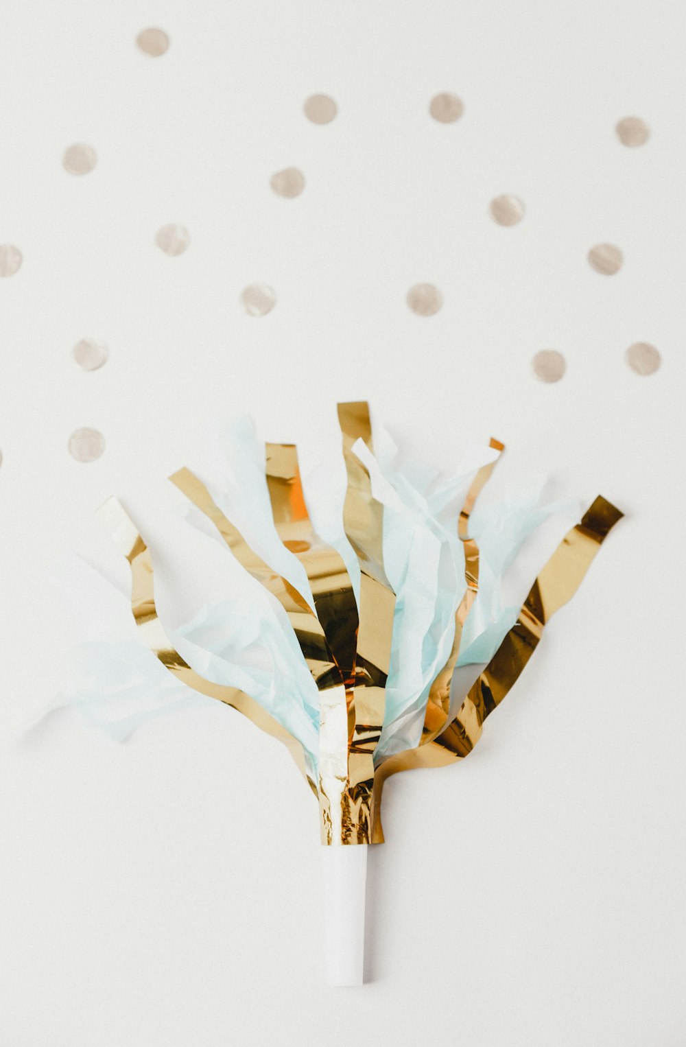 white and brown foil party decor on white panel