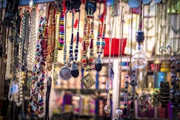A vibrant display of gold and silver necklaces hanging elegantly.