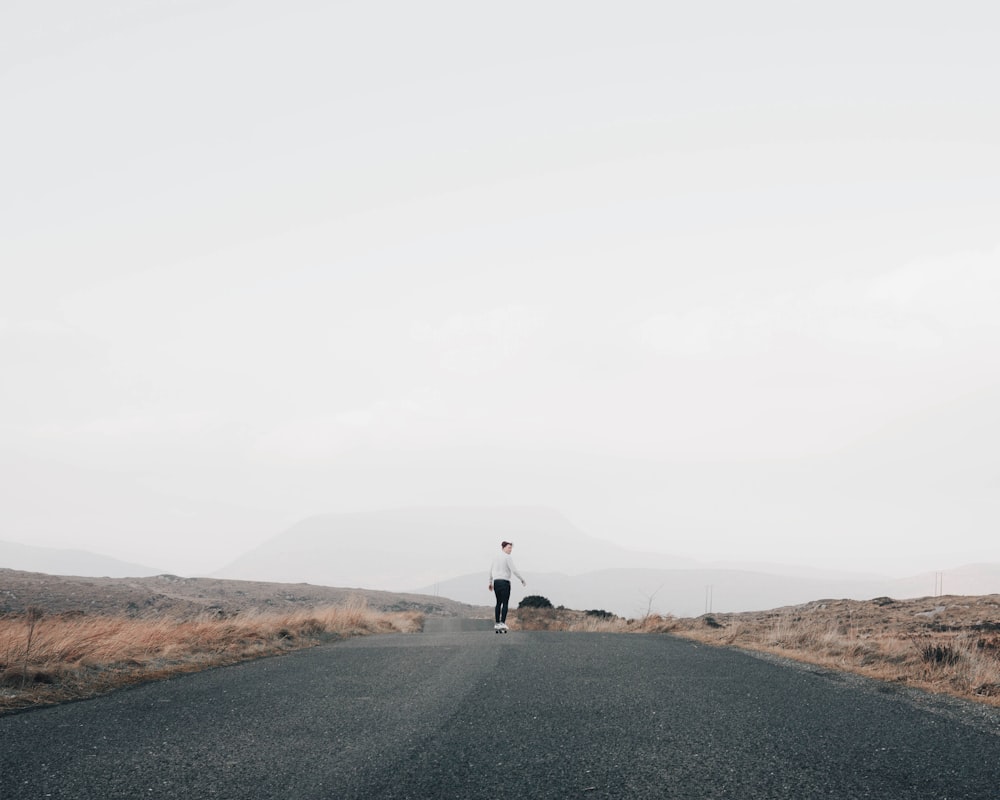 man walking on road during daytime