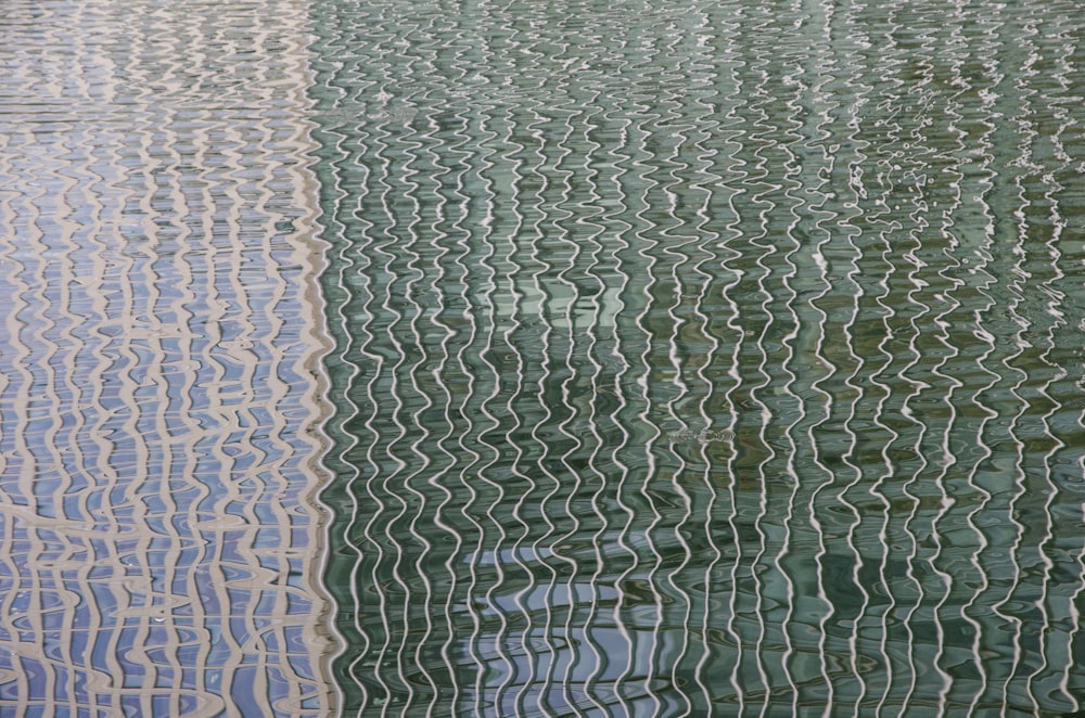 the reflection of a boat in the water