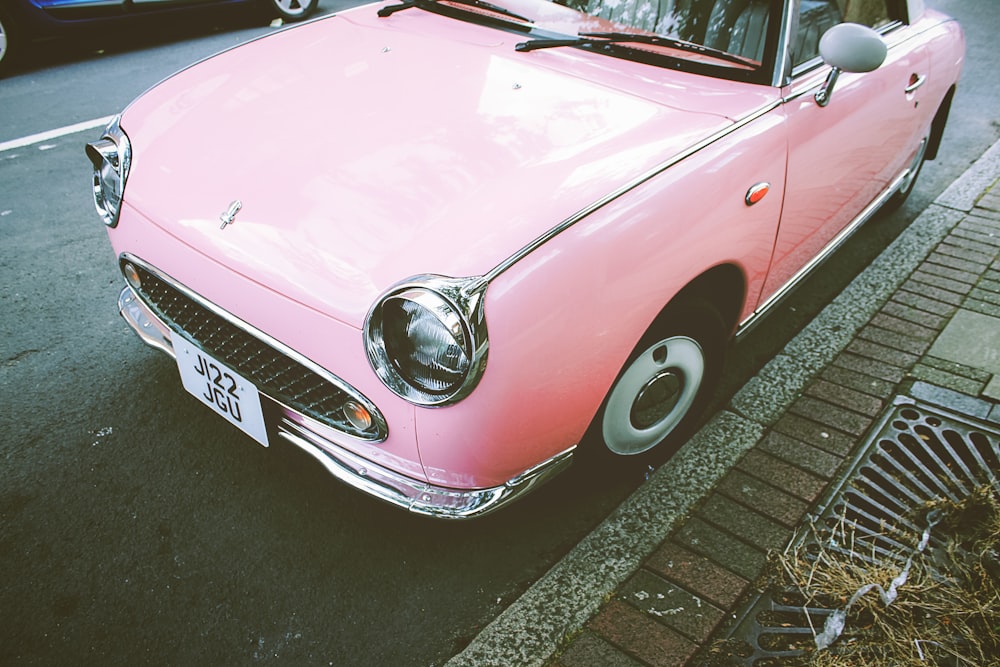 pink car beside drainage during daytime