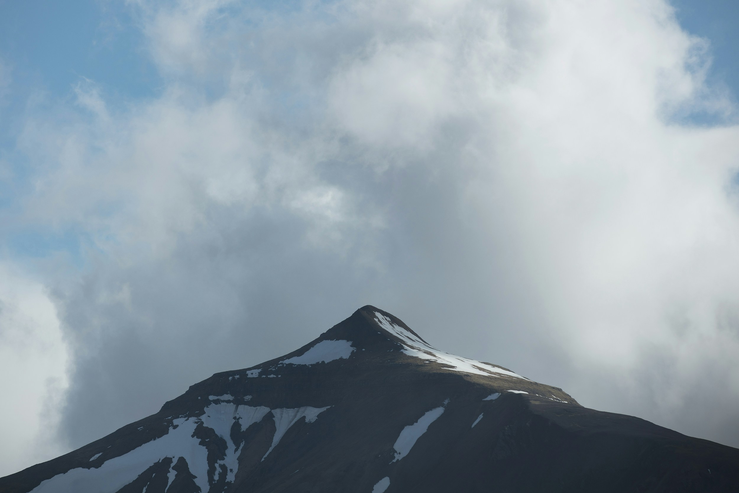 snow-covered mountain under blue sky