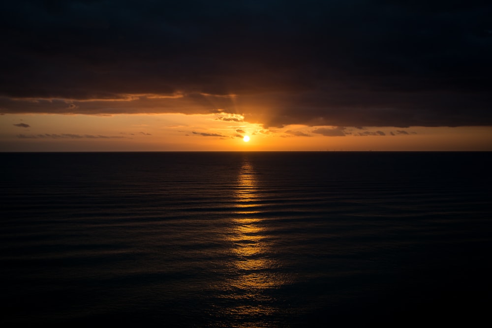 horizon of body of water and clouds