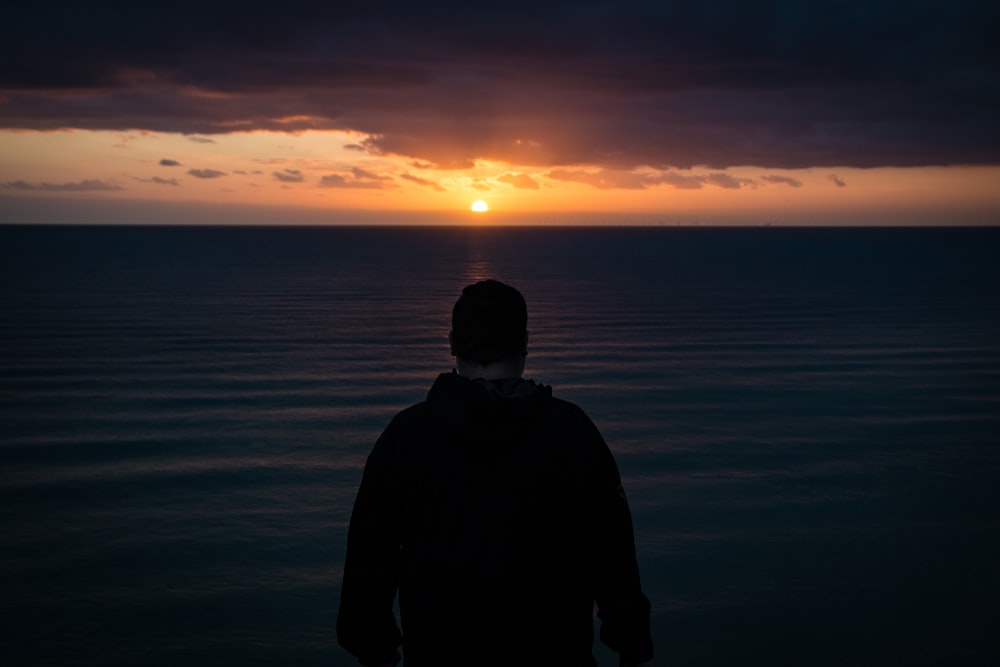 man watching sunset