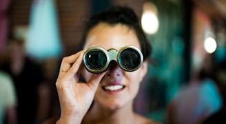 woman using gray binoculars