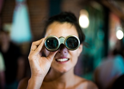 woman using gray binoculars