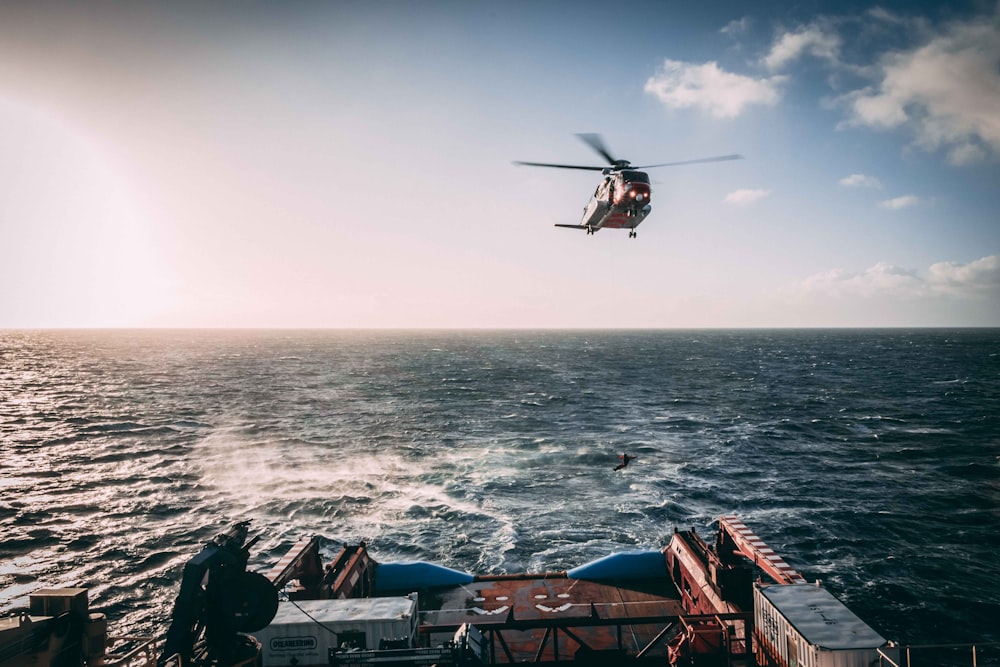 brown helicopter above sea during daytime