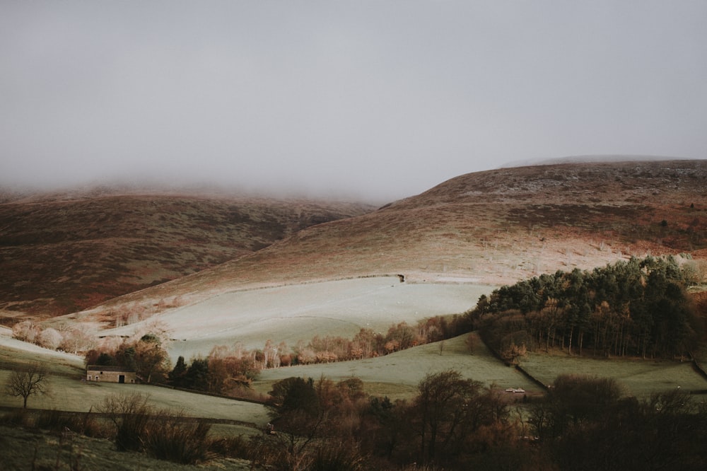 brown mountain under white clouds during daytime