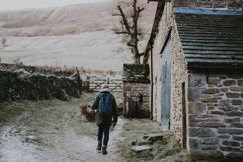 person walking near concrete house