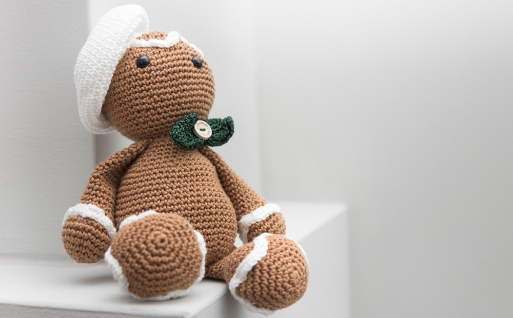 brown and white amigurumi doll