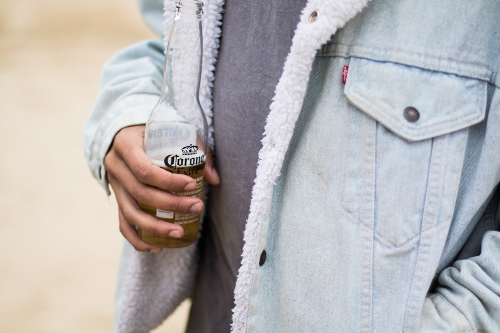 person wearing blue denim jacket