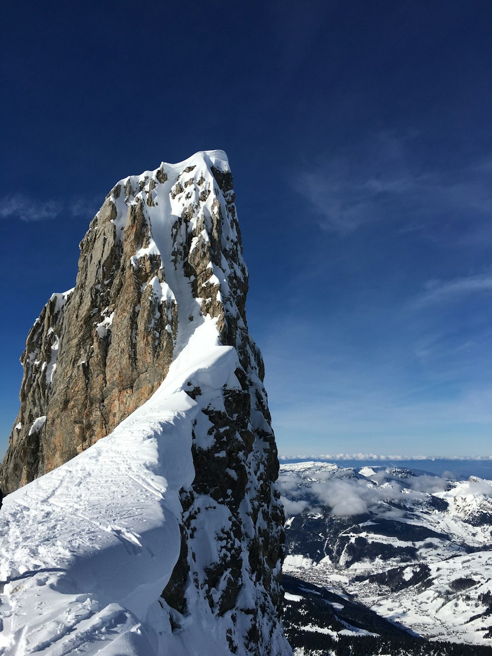 mountain covered in snow under blue sky