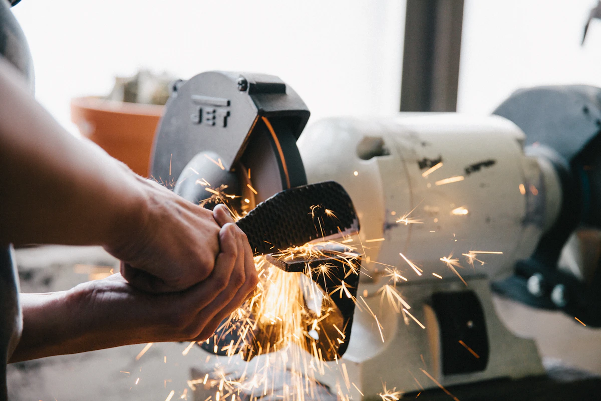 Technician repairing and welding industrial machinery on-site