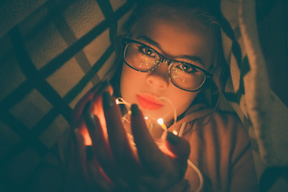 woman holding string light