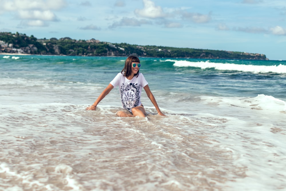 woman in white shirt soaking on sea