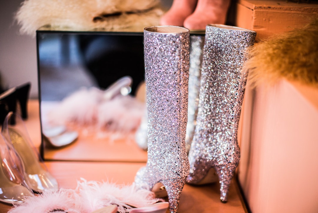 shallow focus photography of pair of women's silver booties