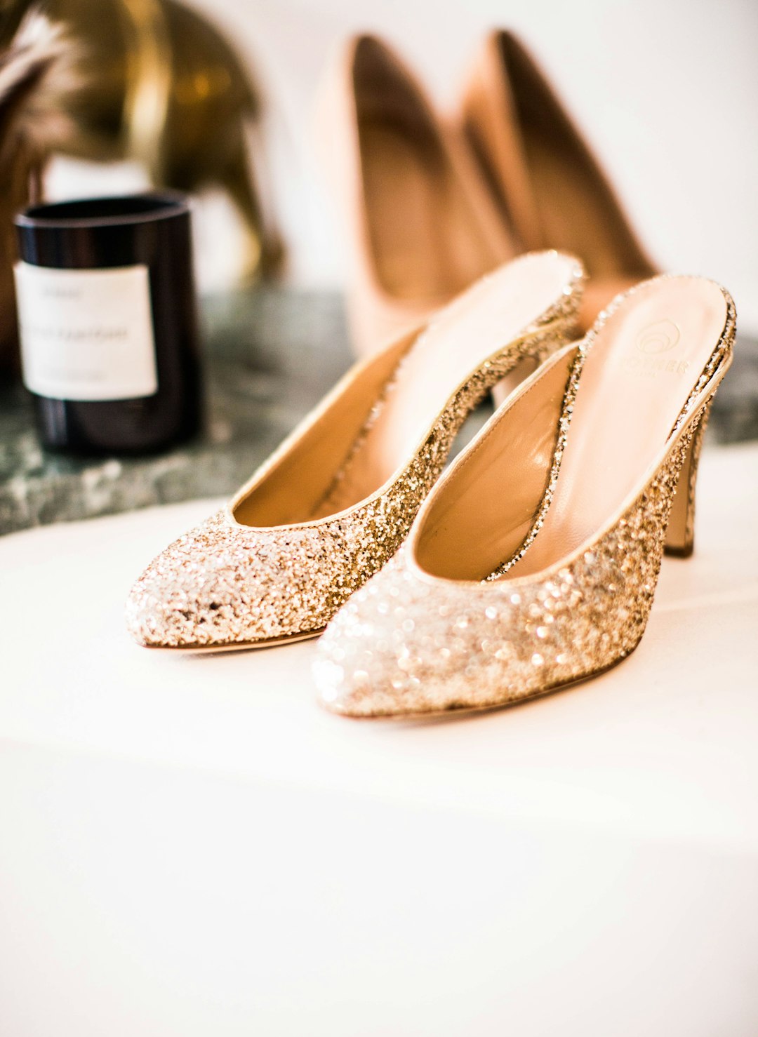 tilt-shift lens photography of glittered gold sandals