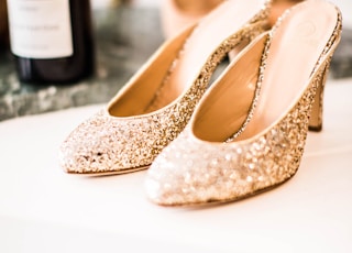 tilt-shift lens photography of glittered gold sandals